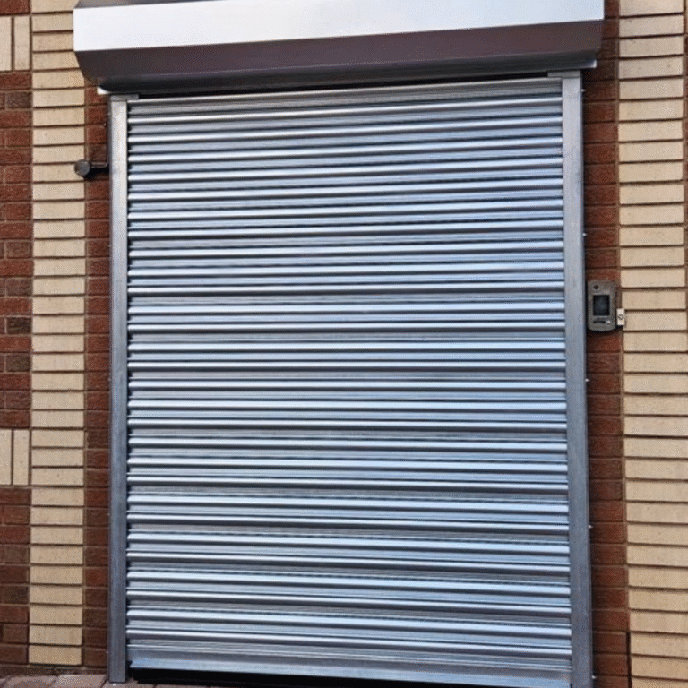 A brown industrial rolling security gate installed on a commercial building storefront.